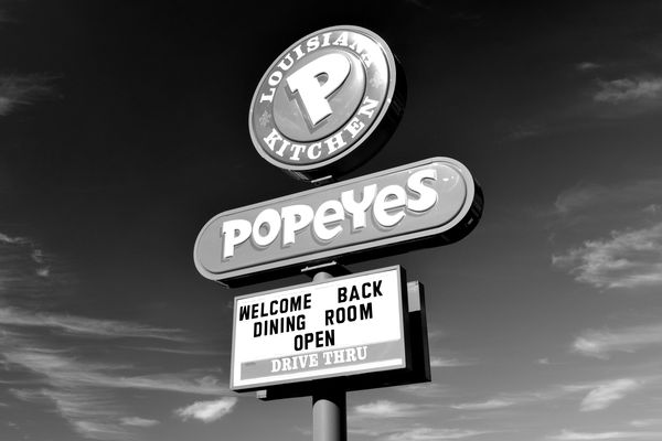 Sign in front of a Popeyes restaurant in Charles Town, West Virginia, after dining restrictions were relaxed, allowing indoor dining with limited capacity.