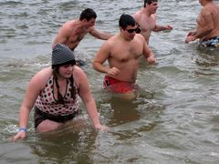 The first plunge is underway, as people run into the ice-cold waters of the Chesapeake Bay.