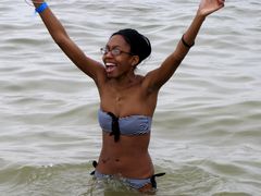 A woman strikes a victorious pose after successfully taking the plunge.