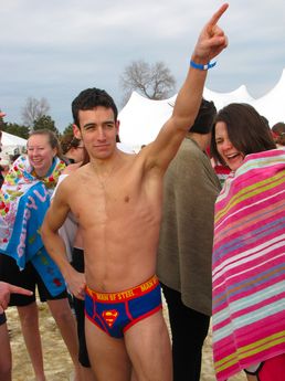 A man wearing Superman-style "Man of Steel" underwear poses for the camera.