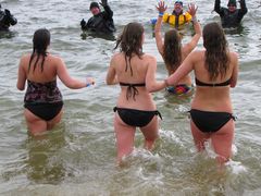 A group of women runs into the water during the second plunge.