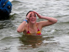 A woman emerges from the water after submerging.