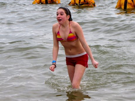 A woman, when leaving the water after taking the plunge, gives a facial expression that says, "<I>What did I just do?</I>"