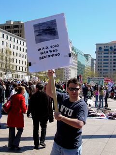 This protester had a number of different signs clipped onto a large pad. This was the first of the series. "In A.D. 2003, war was beginning." Some may not get the reference, but this is indeed a reference to the All Your Base Are Belong To Us Internet meme. I encountered this guy later, and his sign read "All Your Base Are Belong To Us".