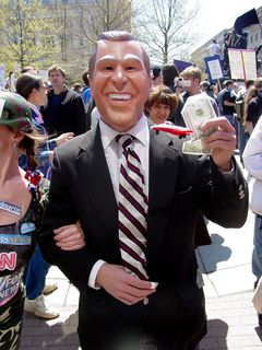 Following this "money" theme, we found protesters carrying American flags altered to show corporate logos instead of stars, a man dressed up as Uncle Sam (the hat also carried this corporate-logo theme), and one man went all out and wore a suit and a George W. Bush mask, holding a modified $1 bill similar to the large sign. His companion had a number of news logos all over her person.