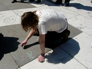 This particular protester doodled his message onto the sidewalk using a piece of green chalk.