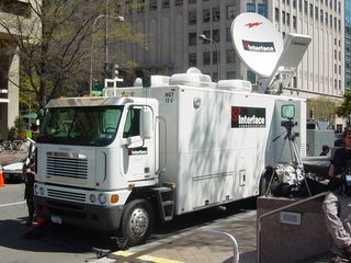 The news media was out in force, as to be expected. Along the perimeter, a communications truck has all kinds of equipment including a big satellite dish, and among the crowds, we found an NBC cameraman shooting video footage.