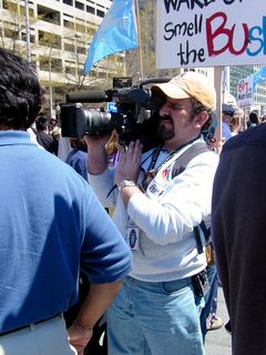 The news media was out in force, as to be expected. Along the perimeter, a communications truck has all kinds of equipment including a big satellite dish, and among the crowds, we found an NBC cameraman shooting video footage.