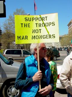 These protesters' signs reflect my own personal sentiment regarding the war. We support our troops, who are doing their best defending our honor. Now, the President and his folks on the other hand... that's another story.