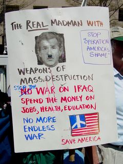 Since when did George Bush have a mustache? Well, no, but look at what style of mustache that it is. It's a Hitler mustache. This was one of a number of posters which denounced Bush as a madman, with a Hitler mustache. The mustache theme was also shared by a number of posters supporting impeaching Bush.