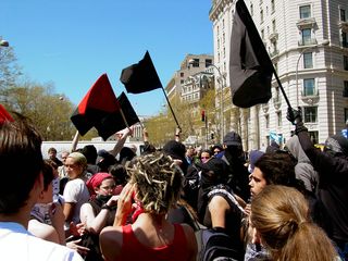 In the street, some protesters waved their black flags high as a chant of "Ain't no power like the power of the people, cause the power of the people don't stop!" rang out.