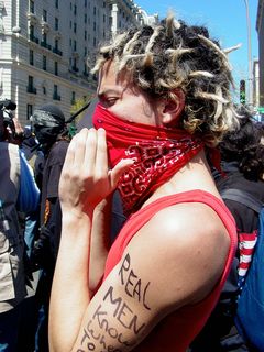 This masked protester, dressed in red, had "Real men know when to stop" written on his left arm, and something else regarding empire on his right arm, but I was unable to make it all out. All the while, he was shouting, along with the group, "Hey, Bush, we know you! Your daddy was a killer, too!"