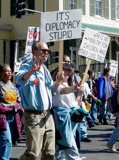 The peace sign flashed by this gentlemen goes very well with his "It's diplomacy, stupid" sign, as he encourages using diplomacy vs. military action.