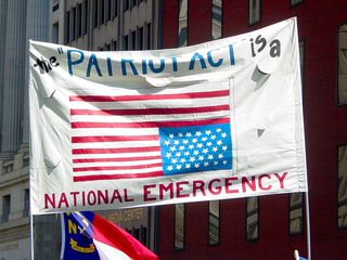 Flying the flag upside down is considered a distress signal, and according to the makers of this sign, the Patriot Act being in place is indeed an emergency.