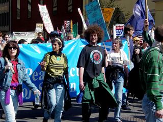 Protesters continued along in a constant stream down the street, carrying all manner of signage...