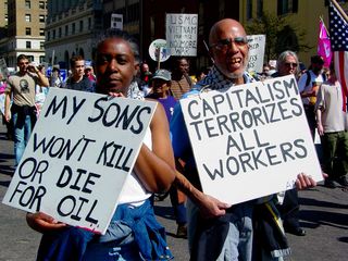 Finally, this couple protests not only the war in Iraq, but also injects a touch of Marxism to the protest, reminding us of Karl Marx's conflict theory, where the world is characterized by inequality.