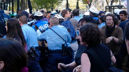 Soon after the black bloc demonsrators passed through, the police decided to bust a move and converge on someone or something. I don't know what caused the action or what the action was targeted against. I was facing the other way when it started, photographing something else. Protesters yelled out, "Shame! Shame! Shame!" as the police did their thing.