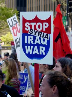 A protester with one of the aforementioned "Stop Iraq War" signs has this time added the word "Syria" to the sign, wondering whether this was the next stop in the war on terror.