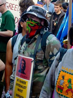 This masked protester, dressed in army fatigues, advocated no imperialist wars, displayed a picture of Che Guevara, and called, like a number of others, for the impeachment of George Bush.