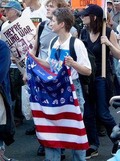 Other familiar scenes make their appearance, as the Patriot Act banner and corporate logo flag finish the protest route.