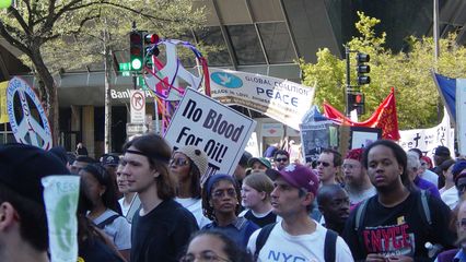 One of the places where people's creativity really came out was in the decoration of peace signs. Just behind the "No blood for oil!" sign, a protester decorated their peace sign with colorful streamers!