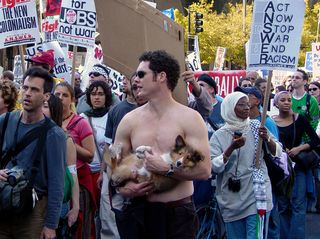 A man carries his dog during the protest