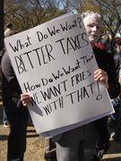 Another sign spoofing the "What do we want? [Whatever]! When do we want it? NOW!" concept.