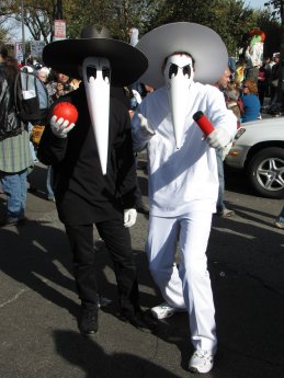 A pair dresses as the black spy and white spy from Mad Magazine's "Spy vs. Spy" feature.