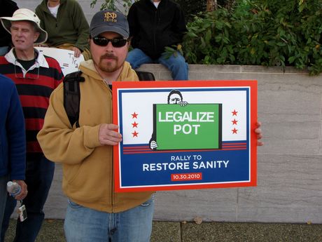 A man holds a pro-marijuana sign.