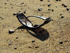 Abandoned pair of sunglasses on the beach.