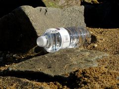 Discarded - but full and unopened - water bottle at the southeast corner of the park, next to a rock jetty.