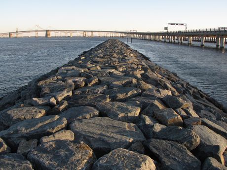 Rock jetty at the west end of South Beach. The Bay Bridge is visible in the distance.