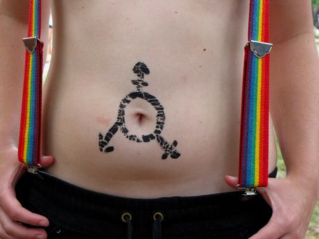 Transgender symbol painted around a person's navel.