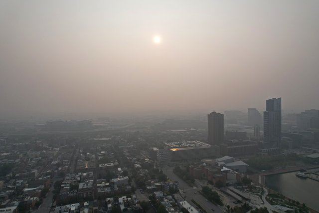 Sun partially obscured by haze over Baltimore