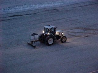 And as "we greet the sun when night is done", people smooth the sand of the beach for the day.