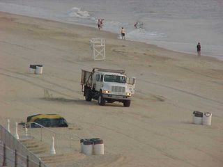 All right! The sun is out! People are starting to come out, and a dump truck is going across the sand...