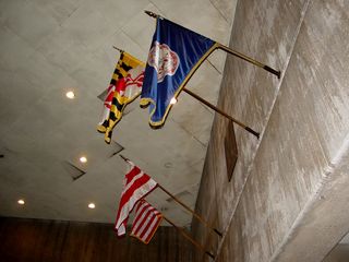 And finally, at the end of all this is the other end of the Union Station Metro station, the entrance to which is decorated with flags of the areas that Union Station and Metro serve - Virginia, Maryland, Washington DC, as well as the flag of the United States. The United States flag is wrapped around its pole slightly, most likely due to wind caused by normal train movements in the Metro station, which are known to cause strong breezes.