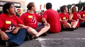 In the picket's final stage, a row of people sat in the street with locked arms as part of a civil disobedience action.