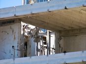 October 4, 2008: Chunks of concrete dangle from steel rebar at the sixth floor level.