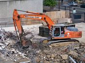 October 13, 2008: An excavator removes steel rebar from a pile of debris.