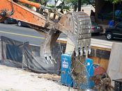 October 13, 2008: An excavator drops scrap metal onto a pile.