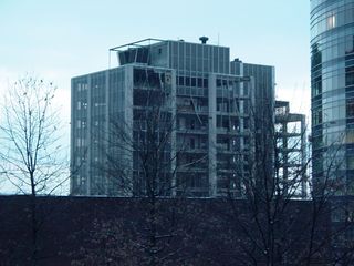 In a January 20, 2005 file photo taken from nearby Rosslyn Center, demolition is underway as removal of the exterior curtain wall is underway.