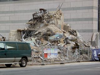 On the other side of the building, a pile of debris waits to be hauled off.