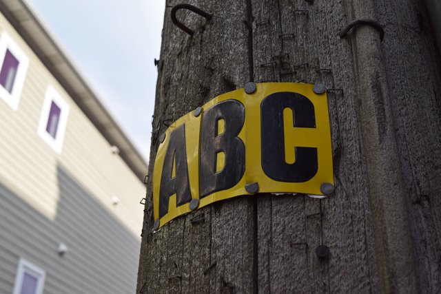 Power line configuration sign on a utility pole.