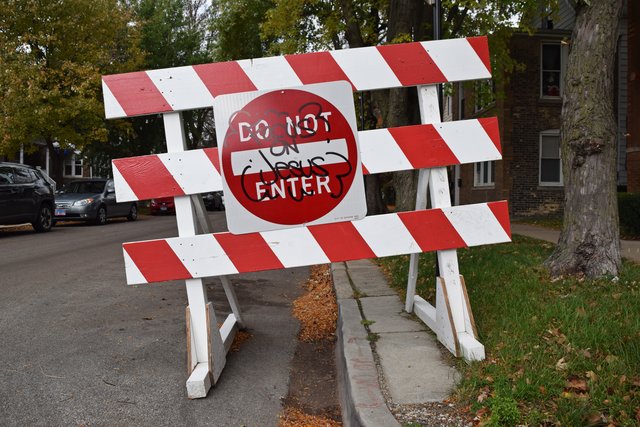 "DO NOT ENTER" sign containing religious graffiti on its face along North Oakley Avenue.