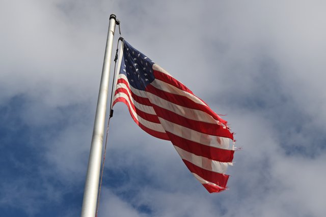 The American flag flies in front of a branch of Wintrust Bank.