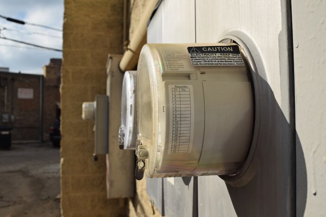 Electric meters in the alley, on the back of the shopping center buildings.