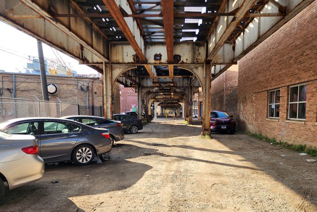 Privately operated gravel parking lot beneath the CTA Brown Line tracks.