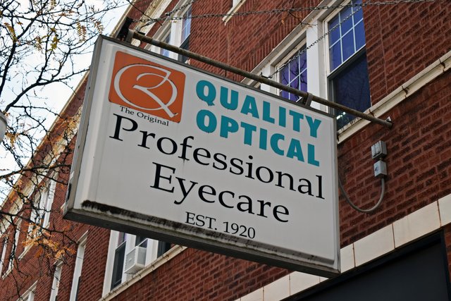 Signage for Quality Optical, along the west side of North Lincoln Avenue.