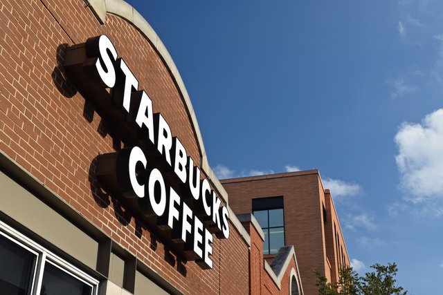 Lighted signage on the Starbucks building's west facade, facing North Lincoln Avenue.